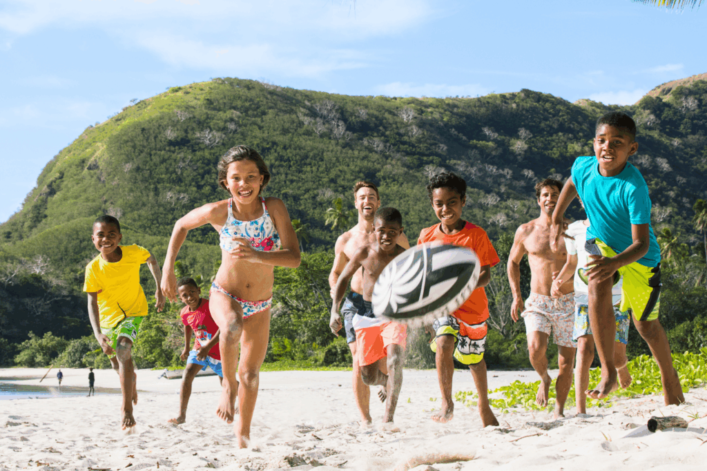 Kids playing rugby on the beach. Photo courtesy of Tourism Fiji.