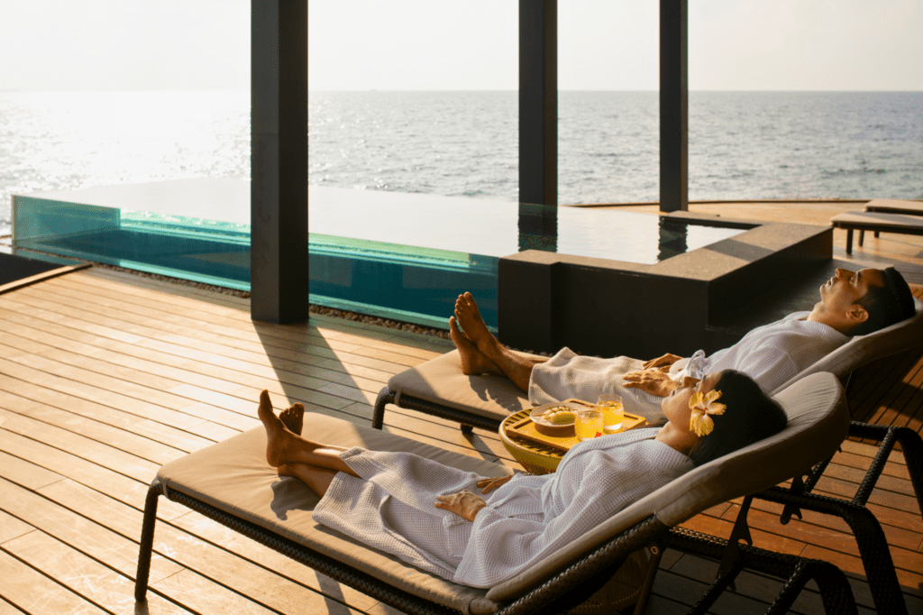 Couple relaxing at Navasana Spa, at the Outrigger Maldives Maafushivaru