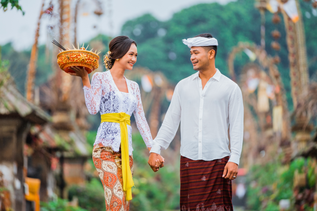 Balinese couple wearing traditional clothes walking together in Bali