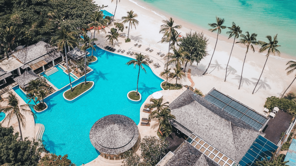 Aerial view over pool and beach at Melati Beach Resort and Spa, Koh Samui