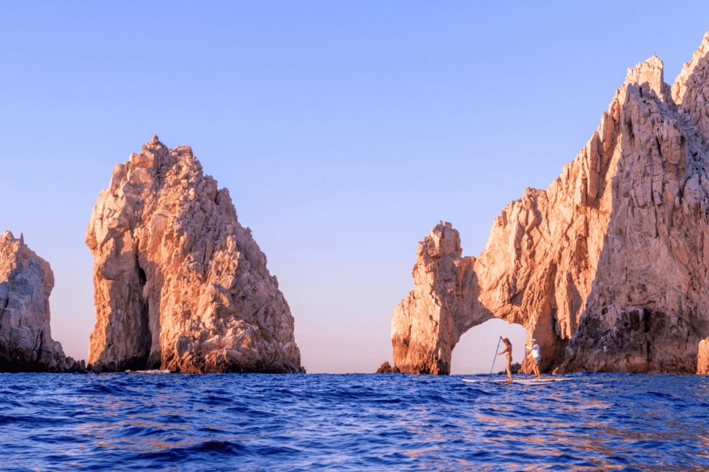 El Arco - Couple stand up paddle boarding at The Arch of Cabo San Lucas