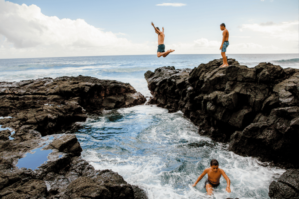 Jumping from rocks into the naturally formed pools at Matareva Beach. Salamumu, Upolu.