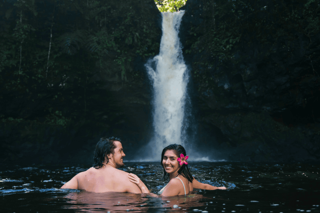Couple swimming at Afu Aau waterfall